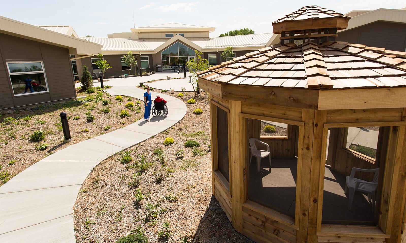 Biggar Integrated Health Centre. Back of facility with landscaped grounds, sidewalks, and gazebo.