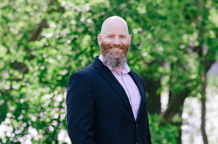 Man with beard smiling at camera