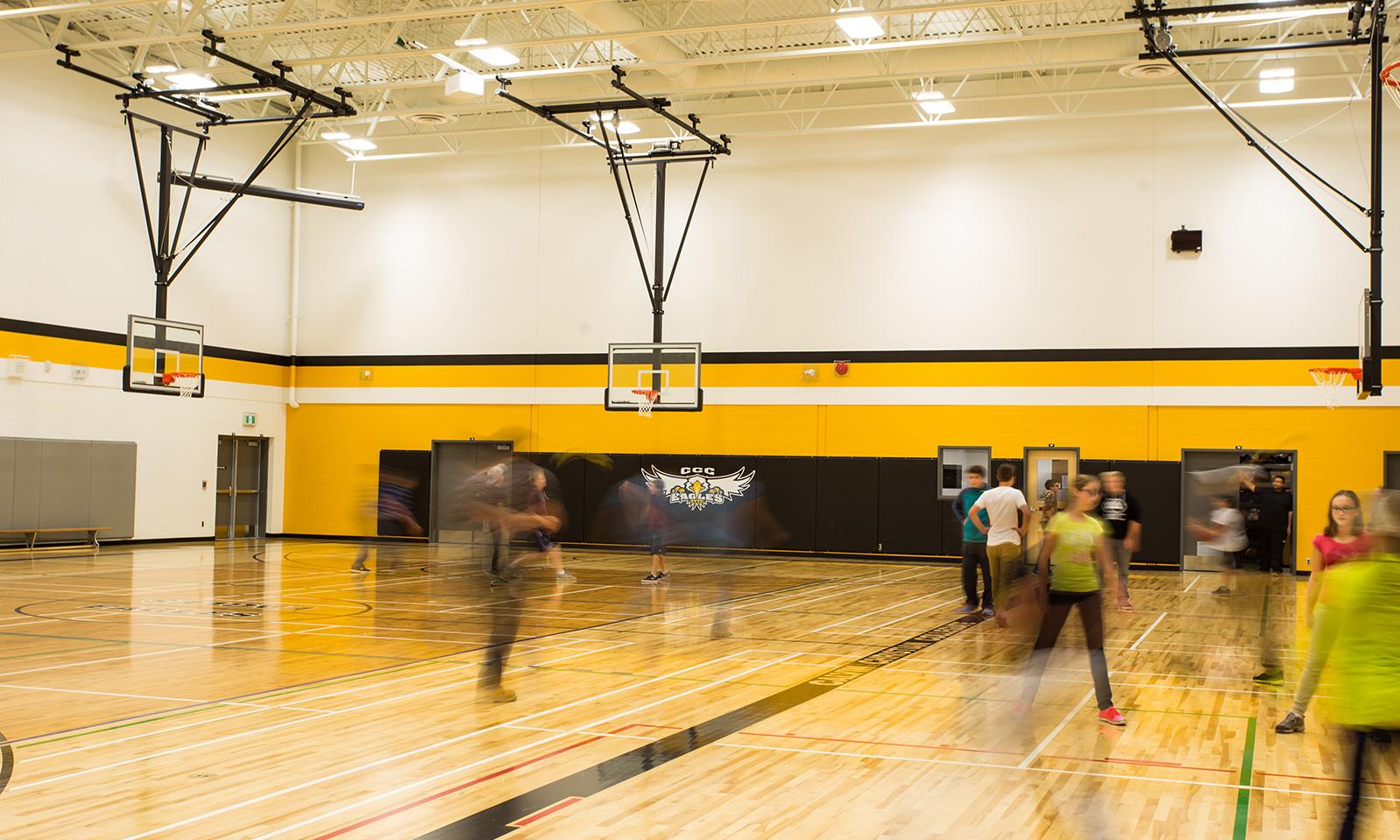 Calvin Christian School. Looking across the gym highlighting the shiny wood floor and the retractable basketball nets.