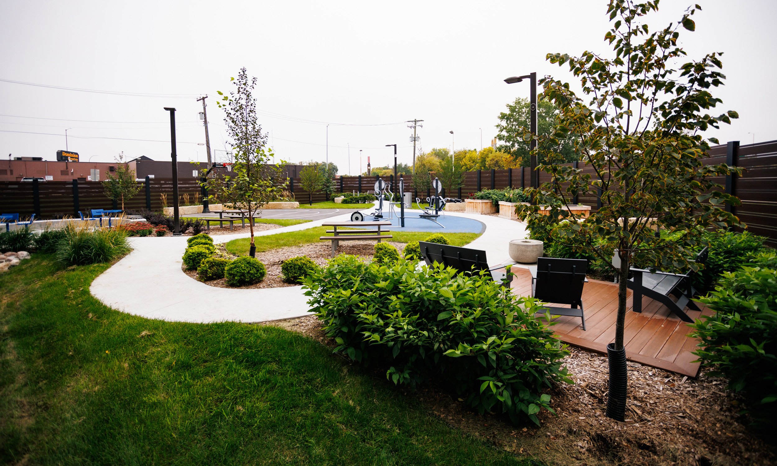Therapy garden featuring lush grass, wooden seating areas
