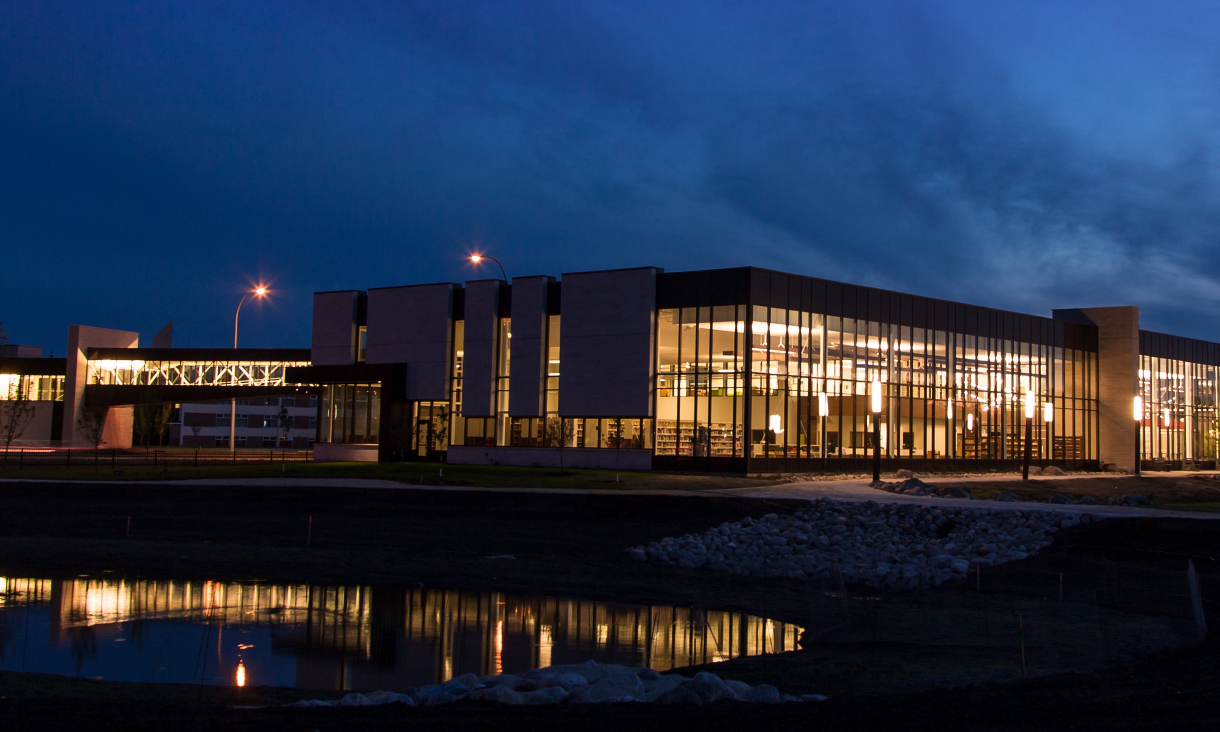 University building at night with skybridge