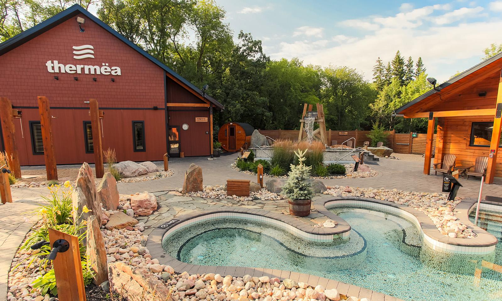 Thermea by Nordik Spa-Nature. Looking across the warm pool toward the Finnish Sauna and Steam Sauna.